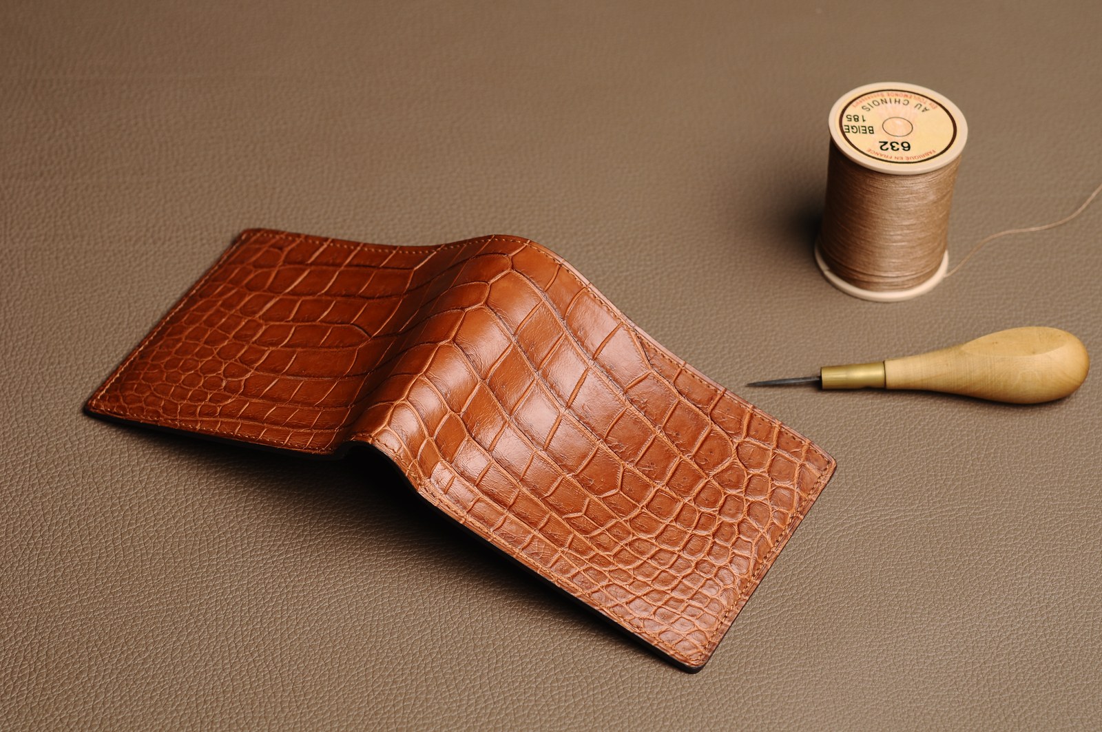 Leather goods components and tools arranged on a product development workbench