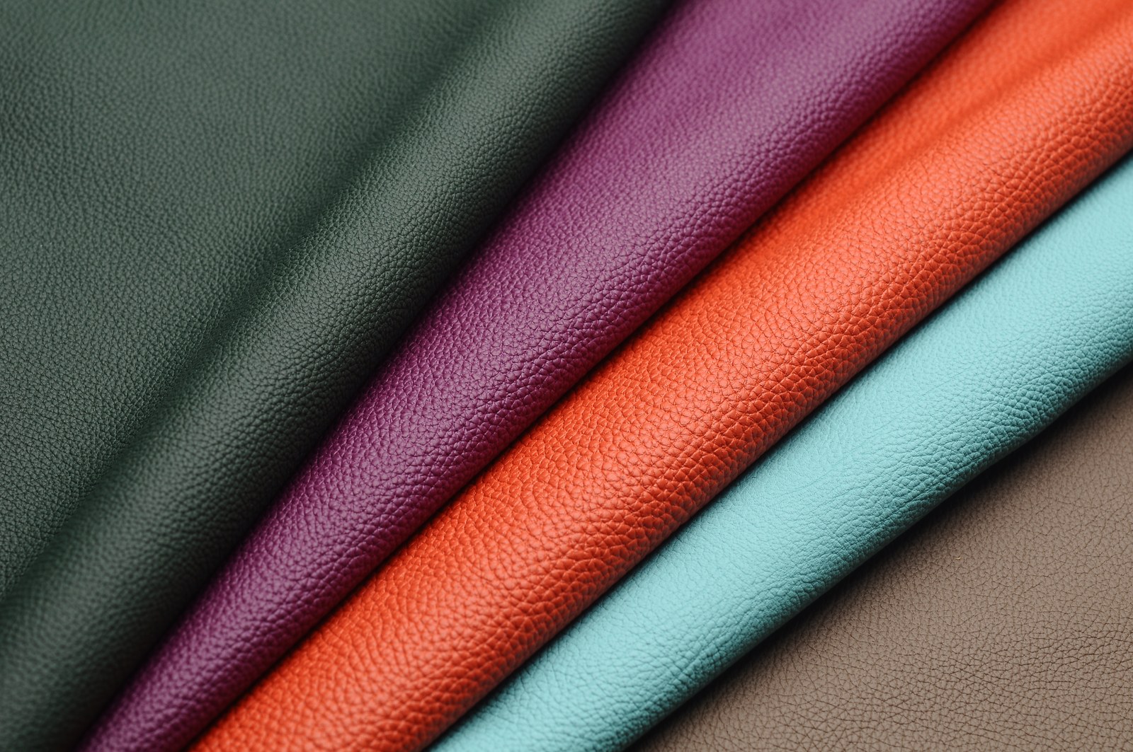 Leather rolls in deep green, burgundy, orange, light blue and brown