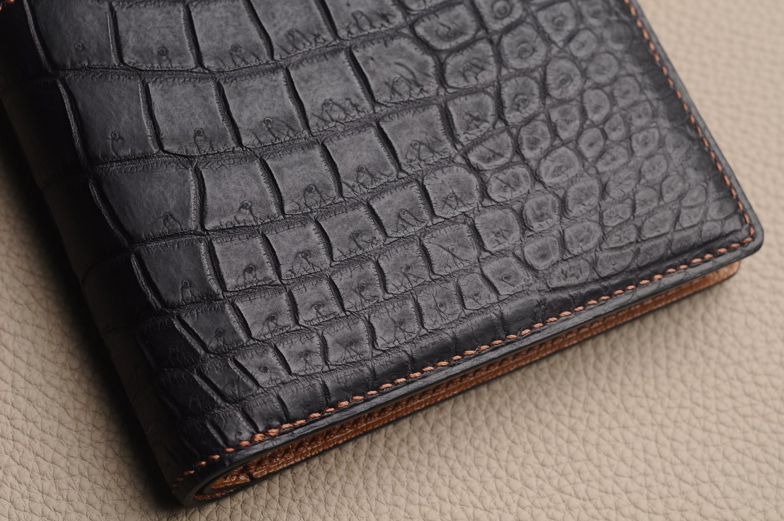 Black crocodile leather wallet edge with brown lining and stitching