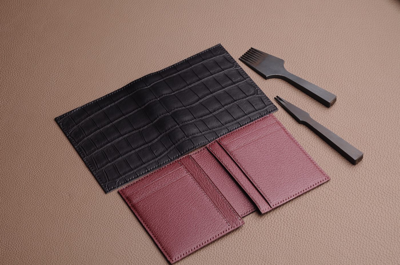 Black small leather goods and wallet components arranged for production