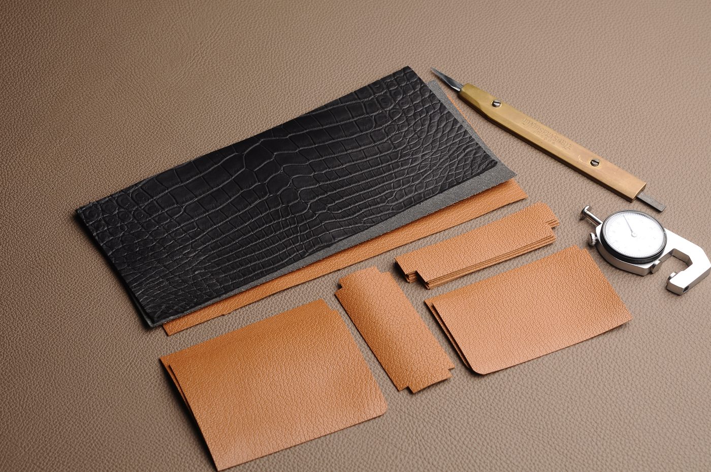 Wallet parts, tools and leather pieces prepared for custom assembly