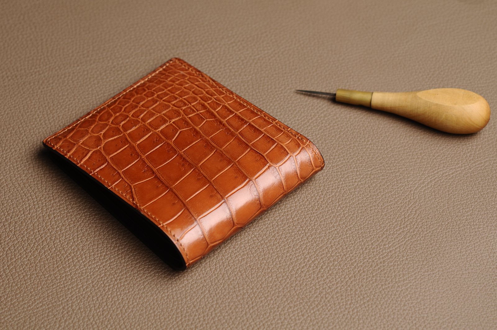 Brown short wallet exterior with crocodile texture